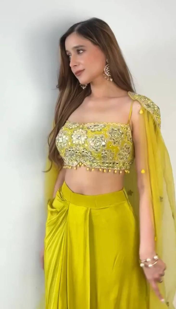 Side view of elegant draped dhoti set, highlighting the flowy shrug and detailed embroidery on the blouse.







