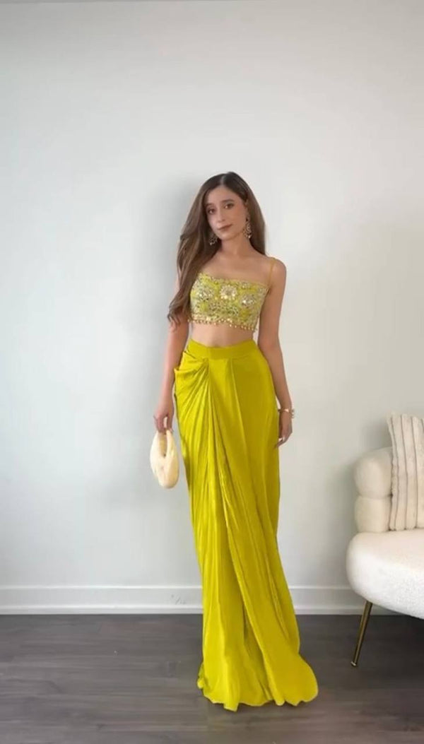 Full view of designer dhoti set with embroidered shrug, tube blouse, and draped dhoti in French silk.

