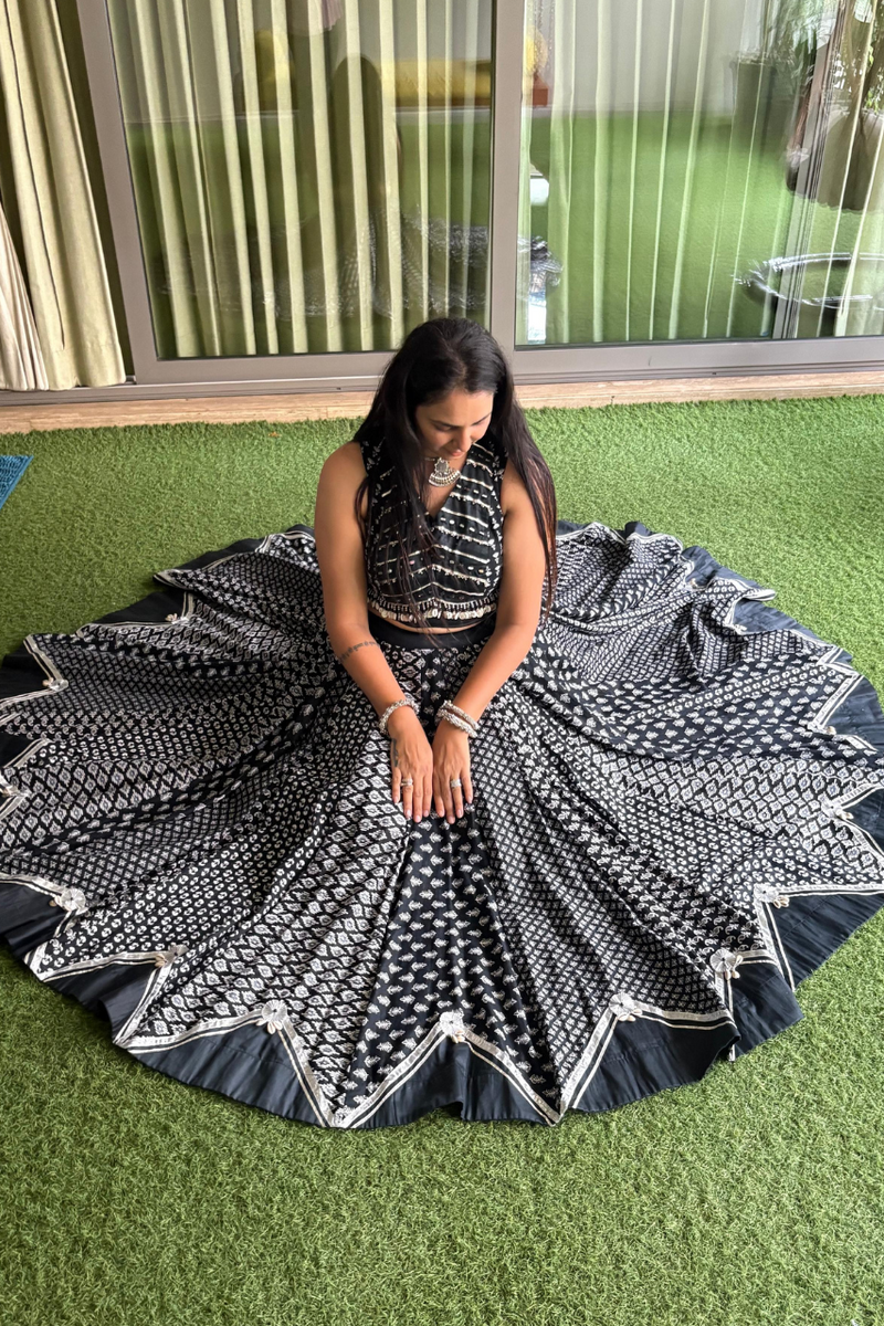 This mesmerizing black lehenga choli set features traditional block prints